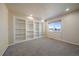 Bright bedroom with built-in shelving and carpet at 23541 E Portland Way, Aurora, CO 80016