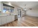 Bright kitchen features white cabinets, stainless steel appliances, and vinyl flooring at 23541 E Portland Way, Aurora, CO 80016