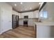 Modern kitchen with white cabinets and stainless steel appliances at 23541 E Portland Way, Aurora, CO 80016