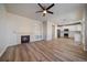 Open concept living room and kitchen with a fireplace and vinyl flooring at 23541 E Portland Way, Aurora, CO 80016