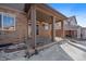 Covered patio with brick and stone exterior at 23541 E Portland Way, Aurora, CO 80016