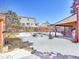 Large backyard with snow-covered ground and a partially visible covered patio at 2066 S Rifle St, Aurora, CO 80013