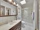 Updated bathroom with walk-in shower, tiled floors, and a modern vanity at 2066 S Rifle St, Aurora, CO 80013