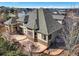 Aerial view of a home with a patio, a well-manicured yard, and a sophisticated roofline at 26426 E Peakview Dr, Aurora, CO 80016