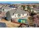 Aerial view of a backyard with a basketball court and a home with a complex roofline at 26426 E Peakview Dr, Aurora, CO 80016