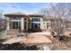 Home exterior featuring a concrete patio, large windows, and mature landscaping at 26426 E Peakview Dr, Aurora, CO 80016