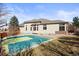 Back exterior shows basketball court, landscaped yard and large windows at 26426 E Peakview Dr, Aurora, CO 80016