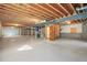 Spacious unfinished basement offering potential for customization with exposed ceiling and concrete floor at 26426 E Peakview Dr, Aurora, CO 80016