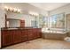 Beautiful main bathroom with double vanity, soaking tub, and a large window at 26426 E Peakview Dr, Aurora, CO 80016