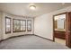 Bedroom featuring a large window, carpeted floor and an attached bathroom at 26426 E Peakview Dr, Aurora, CO 80016