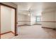 Spacious bedroom with neutral carpeting, a ceiling fan, and classic wood trim along the walls at 26426 E Peakview Dr, Aurora, CO 80016