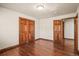 Bedroom with wooden floors and doors to another room and closet at 26426 E Peakview Dr, Aurora, CO 80016