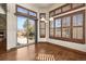 Bright dining area with wood floors, fireplace, and sliding glass door to the outdoor patio at 26426 E Peakview Dr, Aurora, CO 80016