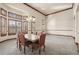 Elegant dining room boasts large windows and a stylish chandelier at 26426 E Peakview Dr, Aurora, CO 80016