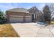 Charming brick home with a three-car garage and large driveway at 26426 E Peakview Dr, Aurora, CO 80016