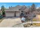 Beautiful brick home showcasing a three-car garage and landscaped front yard at 26426 E Peakview Dr, Aurora, CO 80016