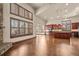 Light-filled living room showcases hardwood floors, many windows, and an island kitchen at 26426 E Peakview Dr, Aurora, CO 80016