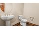 Contemporary powder room features a pedestal sink and modern fixtures at 26426 E Peakview Dr, Aurora, CO 80016