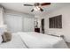Bedroom with ceiling fan, ensuite bathroom, and double closets at 1745 S Kline Way, Lakewood, CO 80232