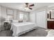 Comfortable bedroom with a ceiling fan, large windows, and ample closet space at 1745 S Kline Way, Lakewood, CO 80232