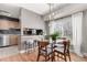 Dining area with kitchen servery, hardwood floors, and adjacent breakfast bar at 1745 S Kline Way, Lakewood, CO 80232