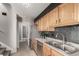 Well-lit kitchen featuring stainless steel appliances, stylish backsplash, and wood cabinetry at 1745 S Kline Way, Lakewood, CO 80232