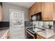 Kitchen has a black cooktop, microwave, and a door to the outside at 1745 S Kline Way, Lakewood, CO 80232