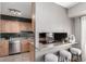 Kitchen passthrough with tiled backsplash and breakfast bar at 1745 S Kline Way, Lakewood, CO 80232