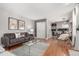 Comfortable living area with hardwood floors, sofa, and an open flow to the dining area at 1745 S Kline Way, Lakewood, CO 80232