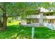 A view of the home with a cozy patio and green yard space at 10369 E Red Mtn, Littleton, CO 80127