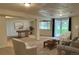 Entertaining basement features games, comfortable seating, and natural light at 10369 E Red Mtn, Littleton, CO 80127