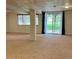 Bright basement with large window overlooking lawn, sliding door and structural support at 10369 E Red Mtn, Littleton, CO 80127