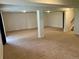 Spacious basement featuring carpeting, white support pillars and potential living area at 10369 E Red Mtn, Littleton, CO 80127