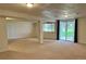 Large, carpeted basement area with sliding glass doors and ample natural light at 10369 E Red Mtn, Littleton, CO 80127