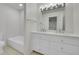 Bathroom featuring double vanity, a bathtub, and bright lighting at 10369 E Red Mtn, Littleton, CO 80127