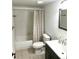 Cozy bathroom featuring neutral tile floors, a modern vanity, shower and tub combo at 10369 E Red Mtn, Littleton, CO 80127