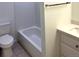Bathroom showcasing a tiled shower/tub combination, toilet, and a vanity with sleek fixtures at 10369 E Red Mtn, Littleton, CO 80127