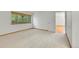 Bright bedroom with neutral carpet, trim, and a large window offering natural light at 10369 E Red Mtn, Littleton, CO 80127