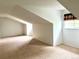 Bedroom features neutral carpet and uniquely angled ceilings, complemented by natural light at 10369 E Red Mtn, Littleton, CO 80127