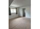Bright bedroom with neutral carpet, a window with curtains, and a connecting door to another room at 10369 E Red Mtn, Littleton, CO 80127