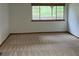 Bright bedroom featuring neutral carpet, white walls, and a large window offering ample natural light at 10369 E Red Mtn, Littleton, CO 80127