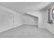 Bright bedroom with neutral carpet, large window, and closet at 10369 E Red Mtn, Littleton, CO 80127