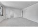 Large bedroom with neutral carpet, closet, and multiple doorways at 10369 E Red Mtn, Littleton, CO 80127