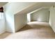 A spacious bedroom with neutral carpet and unique angled ceilings for added character at 10369 E Red Mtn, Littleton, CO 80127