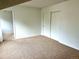 Spacious bedroom with neutral carpet, white walls, and closet space at 10369 E Red Mtn, Littleton, CO 80127
