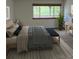 Bright bedroom with view of nature, featuring neutral walls, large windows, and a modern wood platform bed with stylish bedding at 10369 E Red Mtn, Littleton, CO 80127
