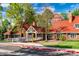Front view of the community clubhouse with red roof, white trim and lush lawns at 10369 E Red Mtn, Littleton, CO 80127