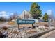 Charming neighborhood entrance sign, 'The Settlement,' amidst well-maintained landscaping at 10369 E Red Mtn, Littleton, CO 80127