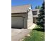 Exterior view featuring an attached garage and well-maintained lawn, with sidewalk leading to entry at 10369 E Red Mtn, Littleton, CO 80127