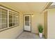 Inviting covered front porch with decorative plant and neutral colors at 10369 E Red Mtn, Littleton, CO 80127